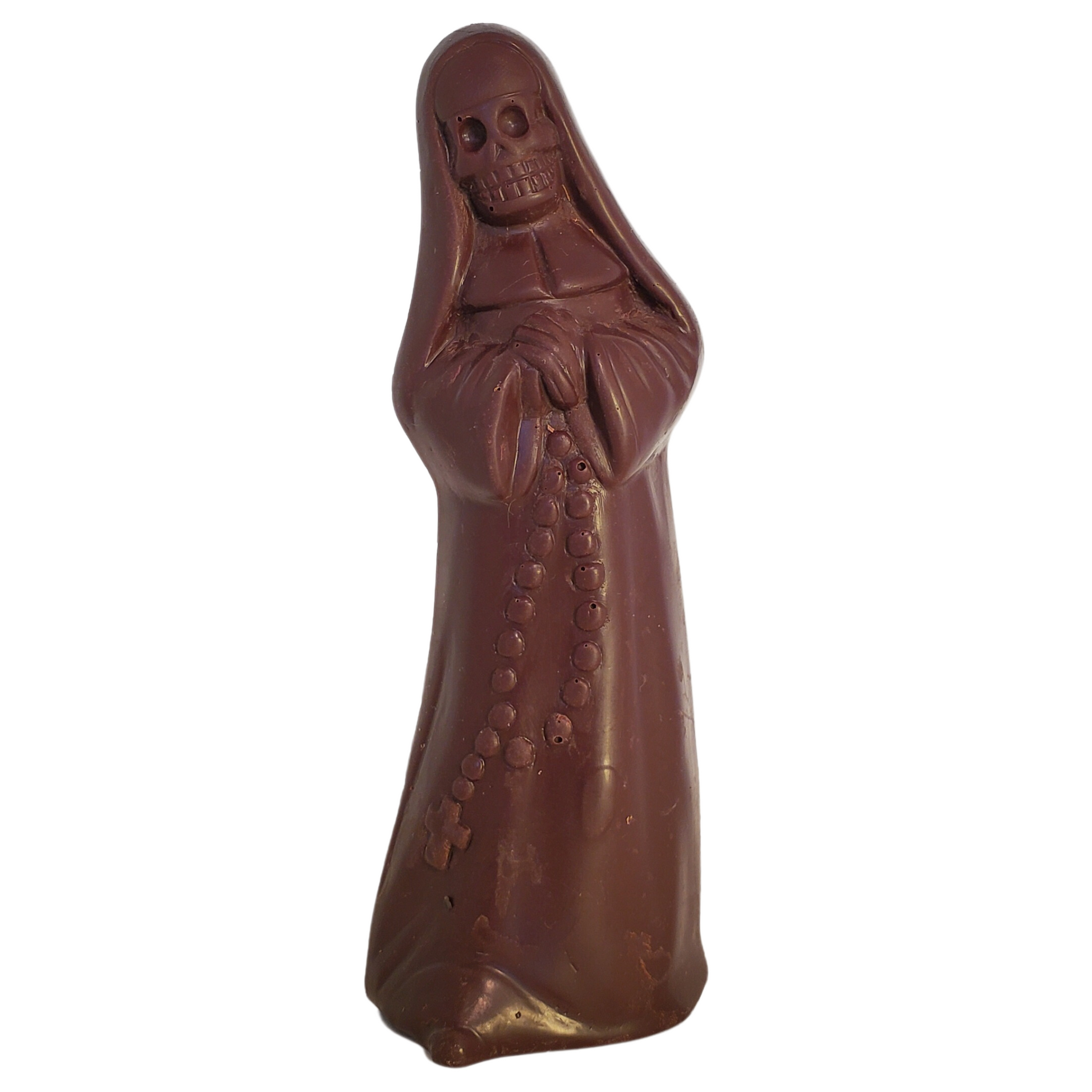 Dark chocolate figure of a nun with a skull face and wearing a long robe.